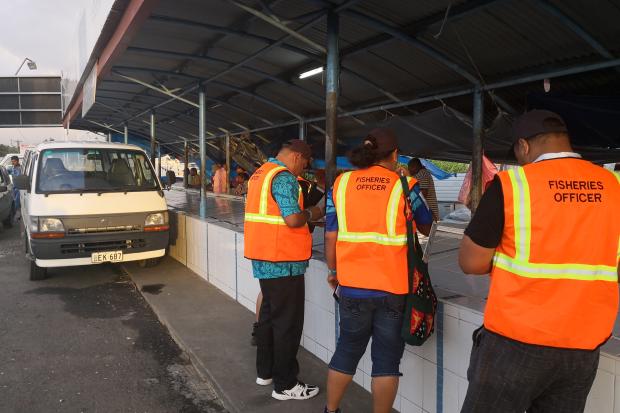 Fisheries inspectors at market in Fiji